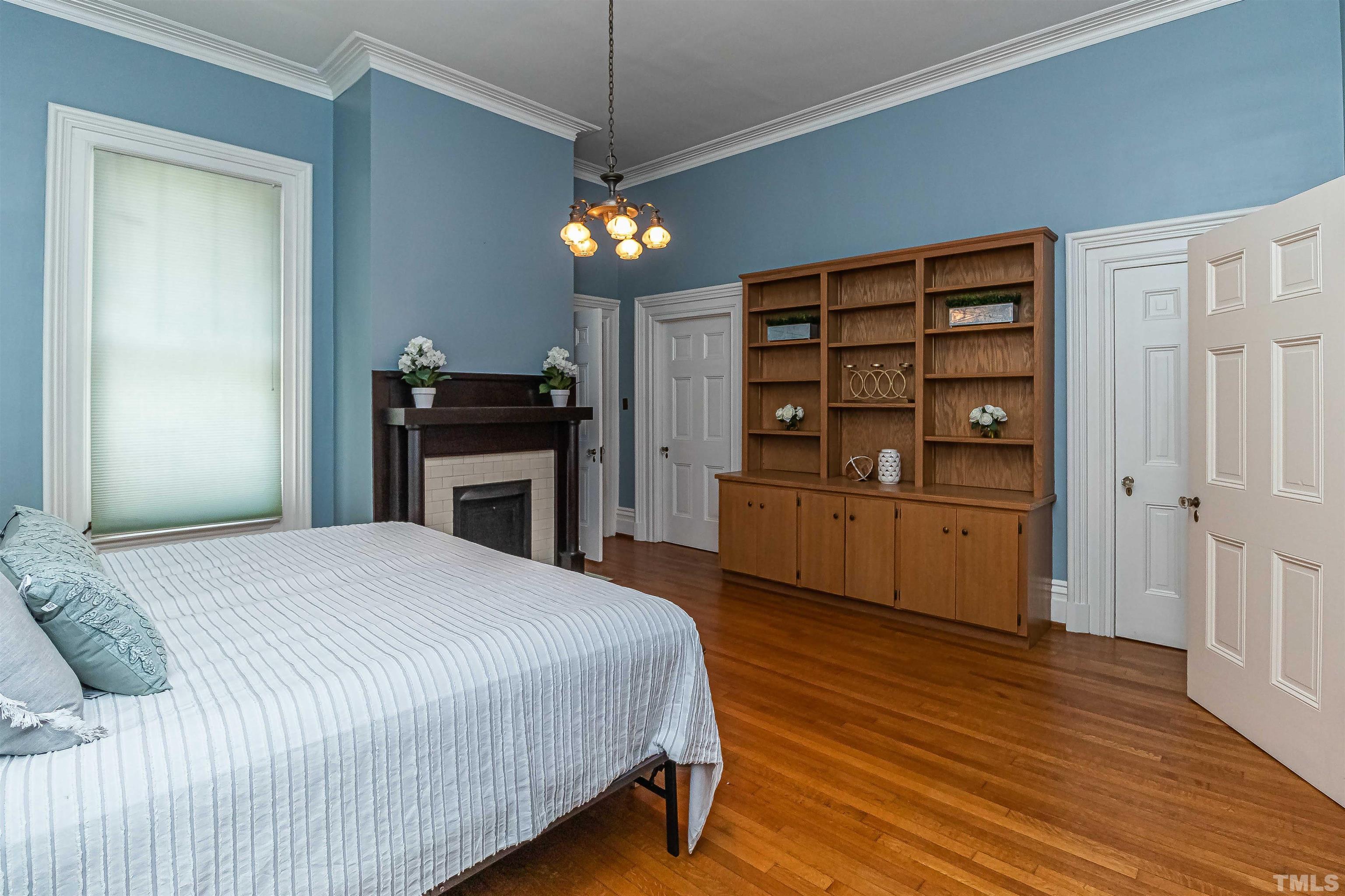 111 South George Street Goldsboro, NC 27530 - Photo 7 of 51 a bedroom with a bed and a flat screen tv