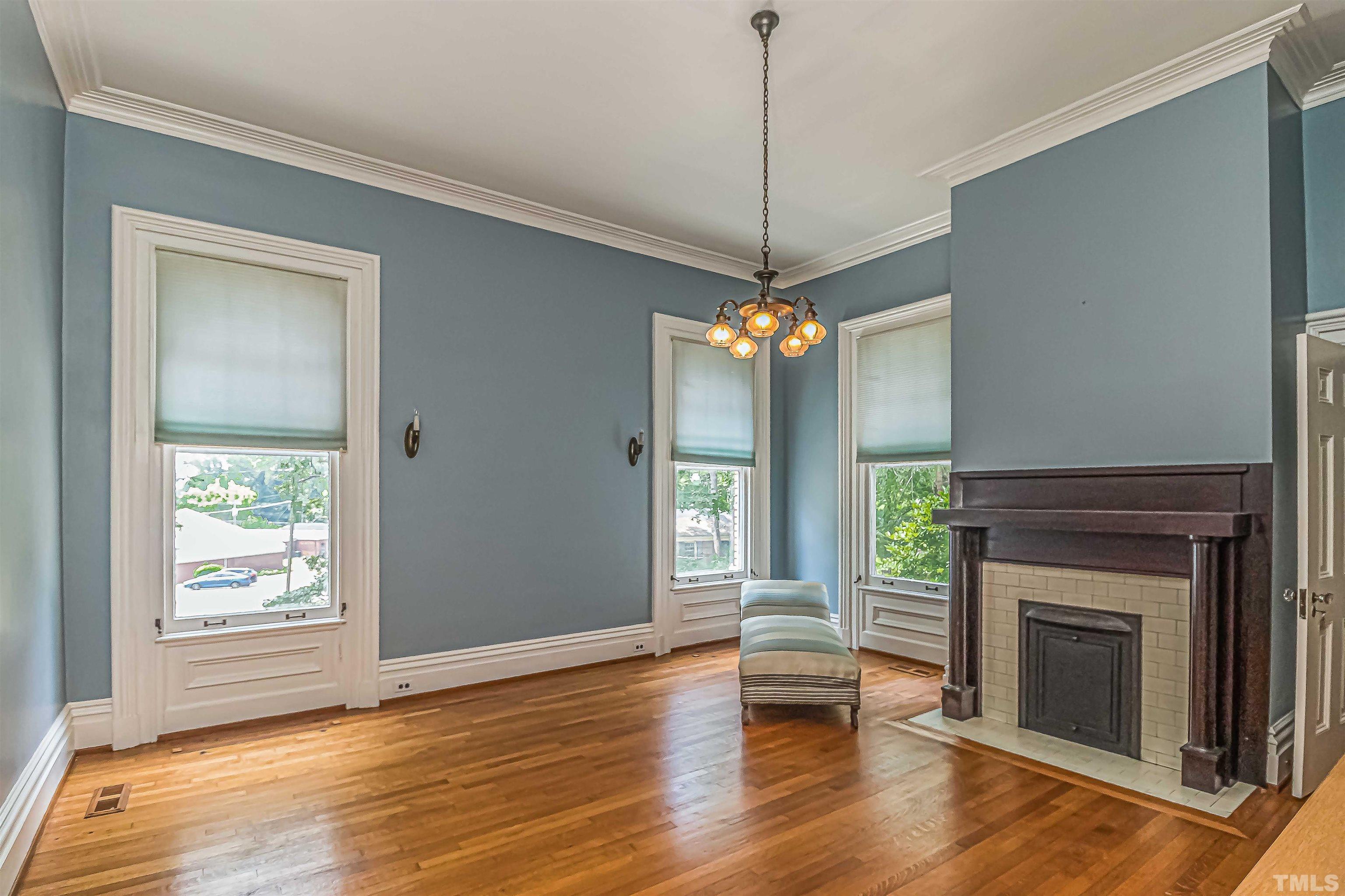 111 South George Street Goldsboro, NC 27530 - Photo 9 of 51 a view of an empty room with wooden floor fireplace and a window