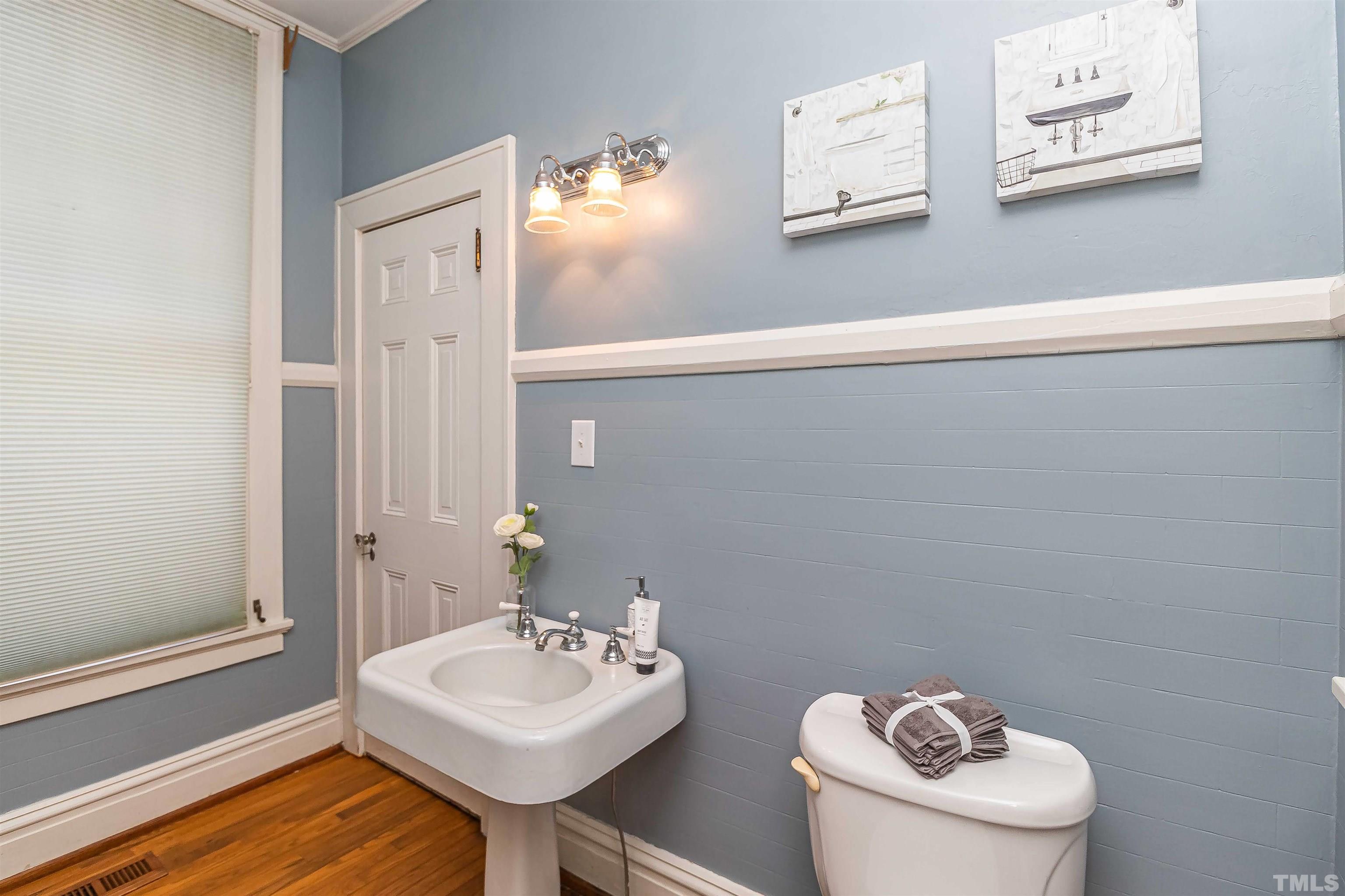 111 South George Street Goldsboro, NC 27530 - Photo 10 of 51 a bathroom with a toilet sink and mirror