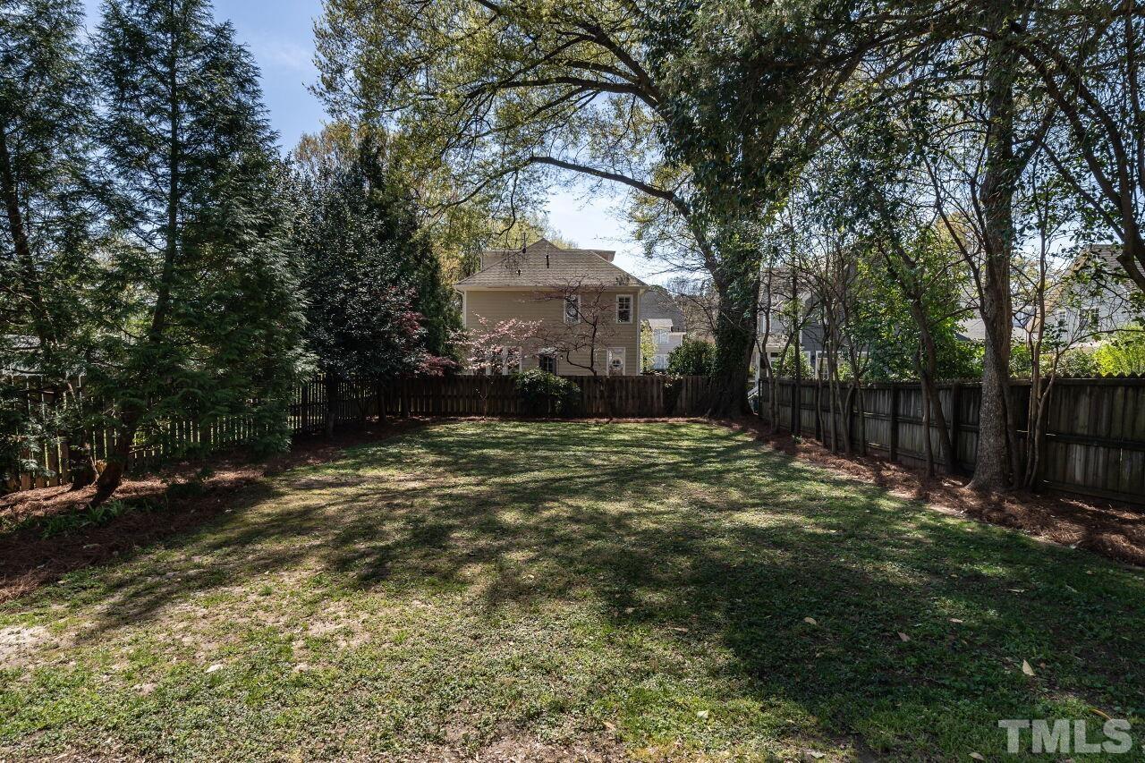 118 East Whitaker Mill Road Raleigh, NC 27608 - Photo 20 of 21 a backyard of a house with lots of green space