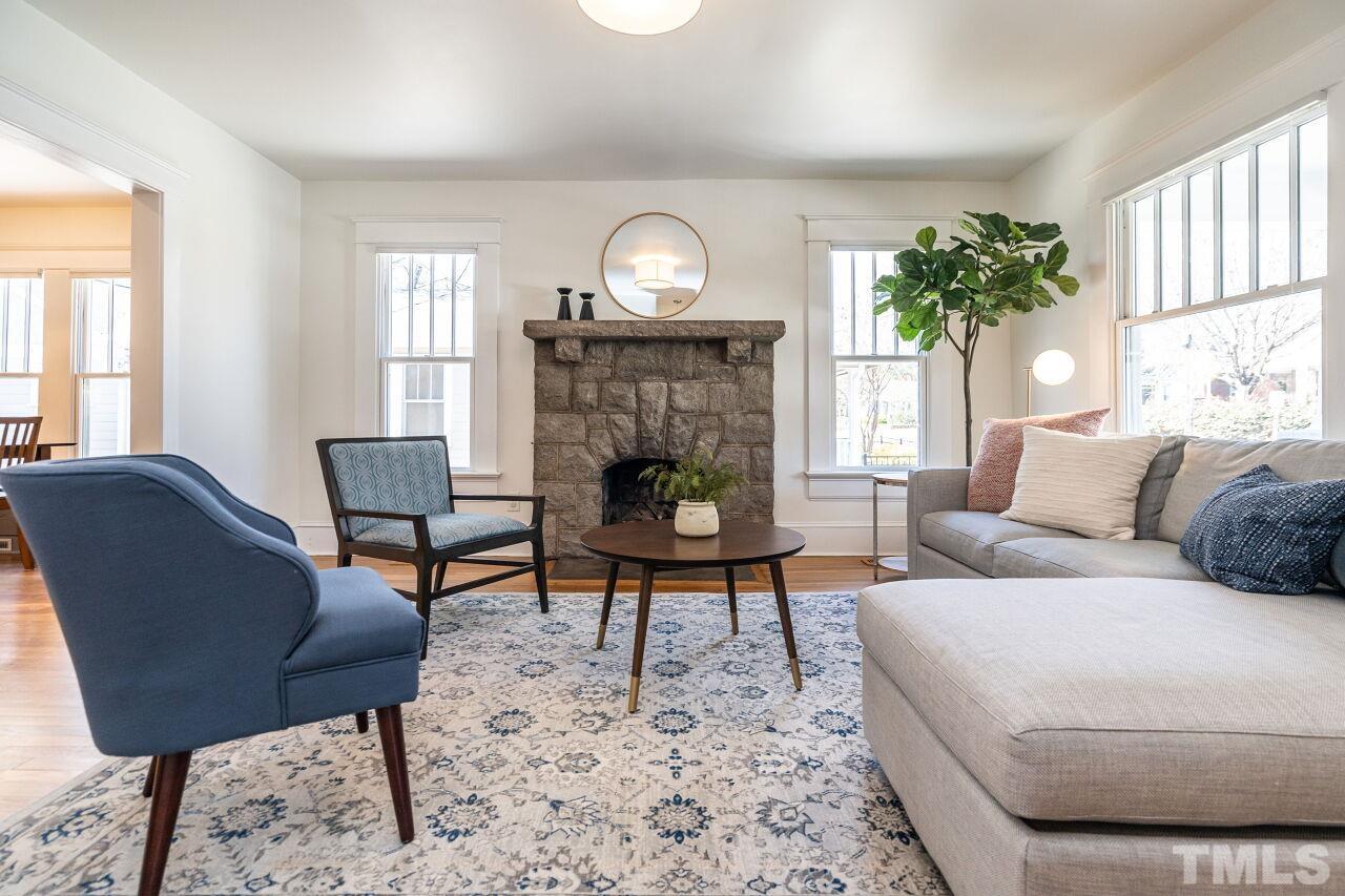 118 East Whitaker Mill Road Raleigh, NC 27608 - Photo 5 of 21 a living room with furniture a lamp a rug and a window