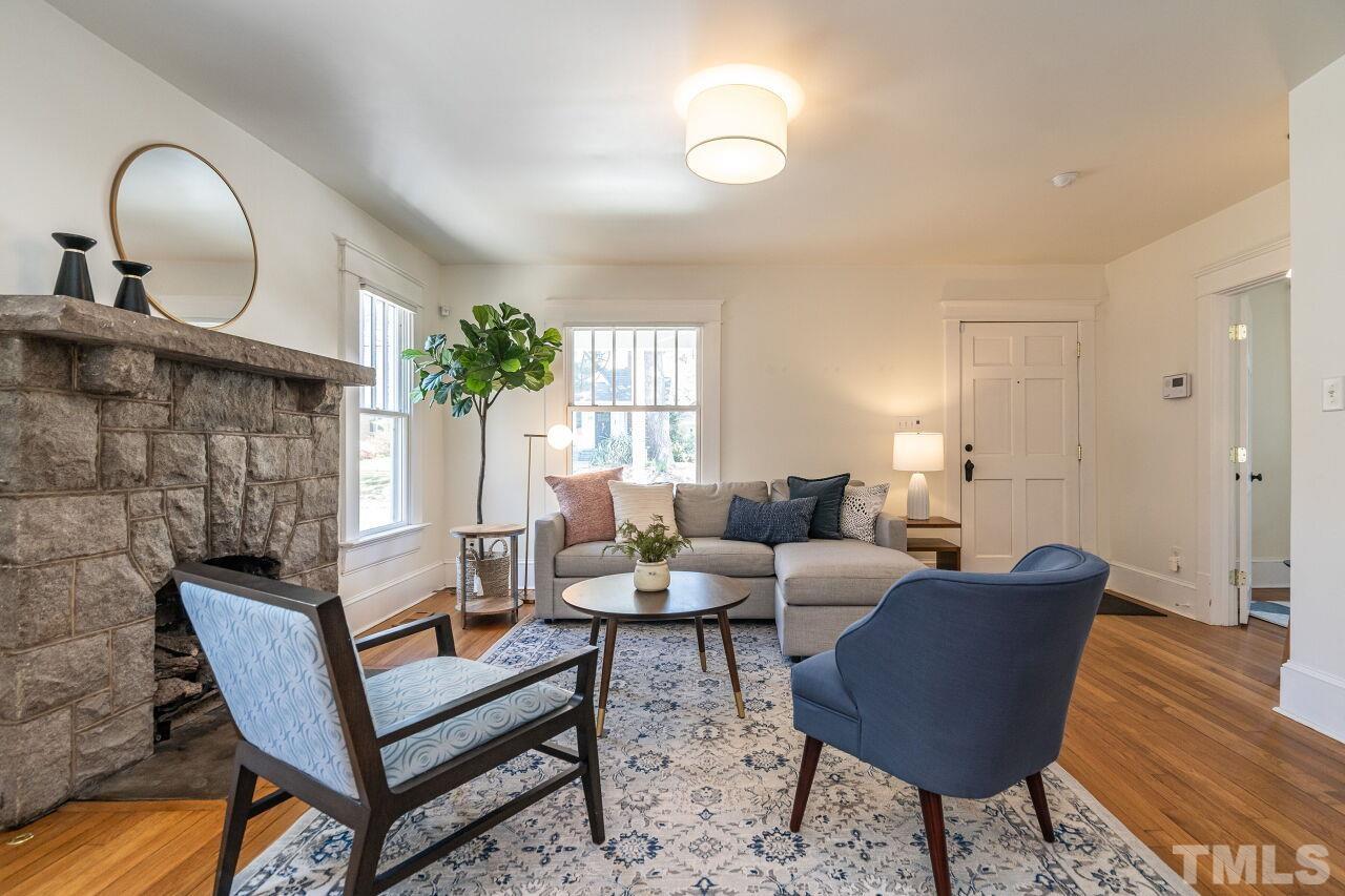 118 East Whitaker Mill Road Raleigh, NC 27608 - Photo 6 of 21 a living room with furniture and a wooden floor
