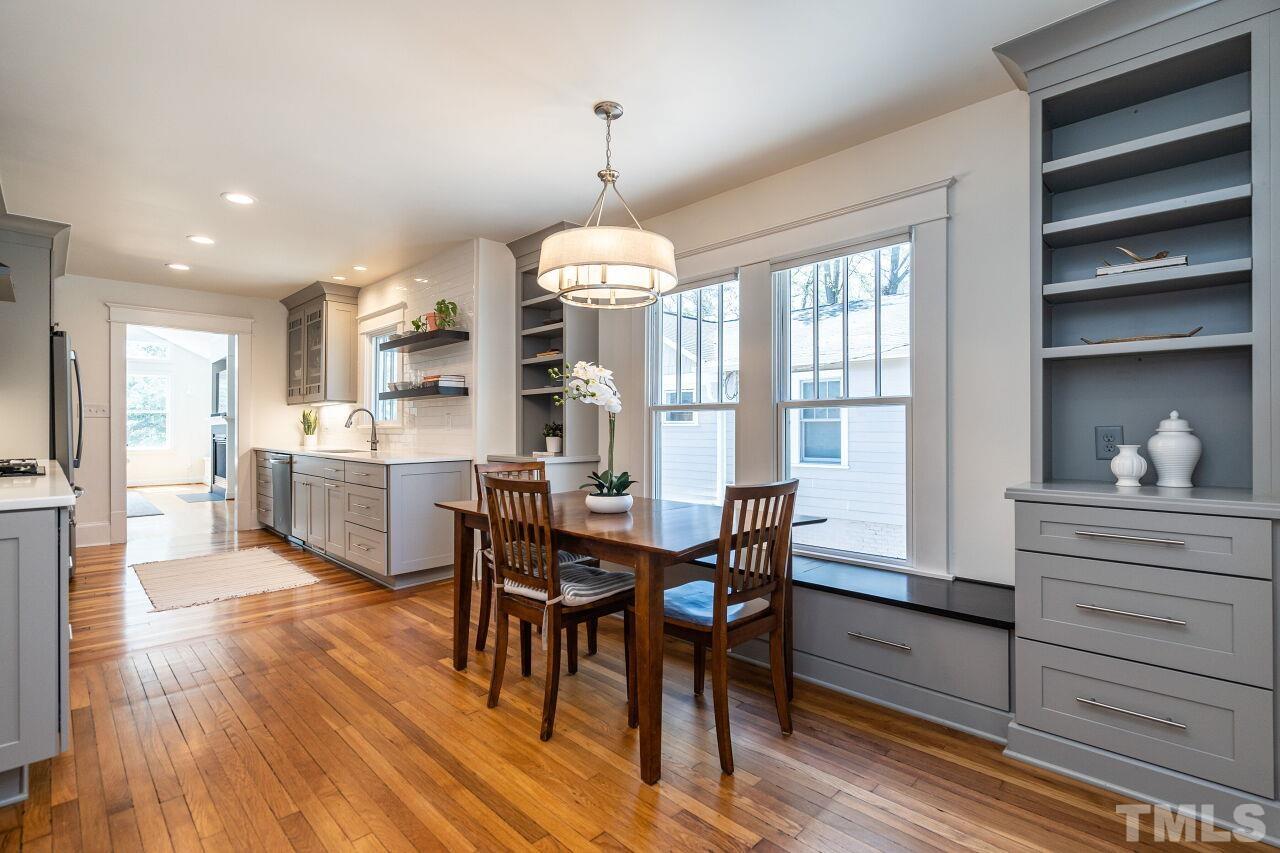 118 East Whitaker Mill Road Raleigh, NC 27608 - Photo 7 of 21 a view of a dining room with furniture window and wooden floor