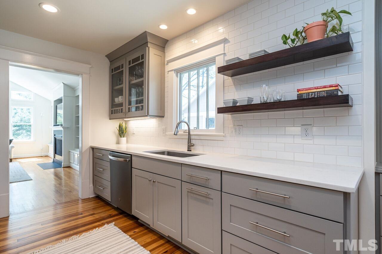 118 East Whitaker Mill Road Raleigh, NC 27608 - Photo 9 of 21 a kitchen with sink and window