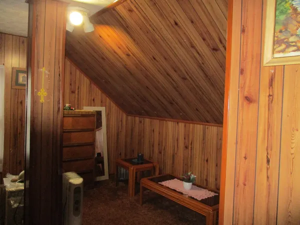 a bedroom with a bed and a flat tv screen
