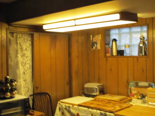 a dining room with furniture and a window