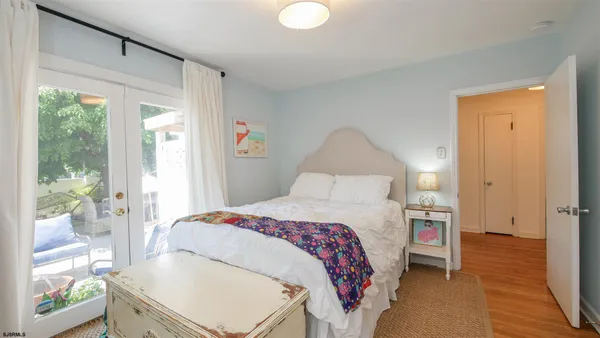 a bedroom with a bed and a large window