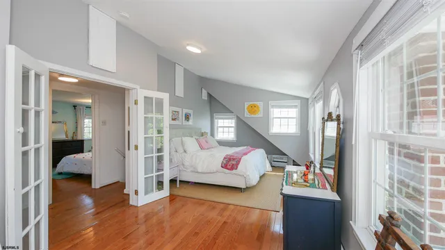 a bedroom with furniture and a wooden floor