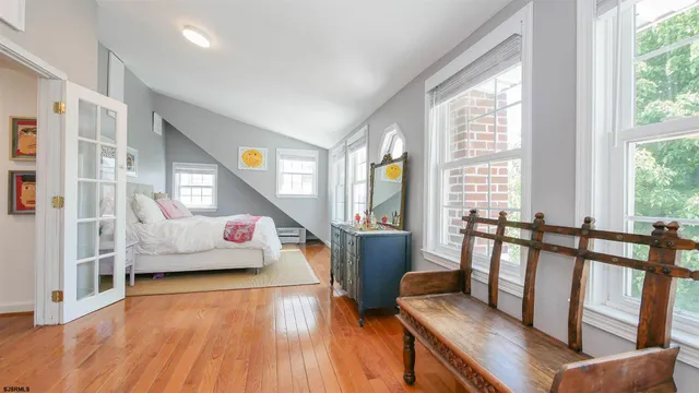 a bedroom with furniture and a wooden floor