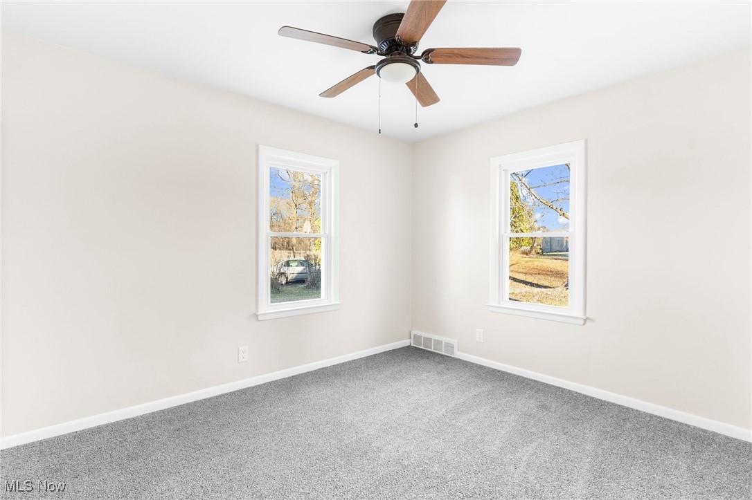3441 Bell Wick Road Hubbard, OH 44425 - Photo 9 of 22 Carpeted spare room featuring ceiling fan and a healthy amount of sunlight