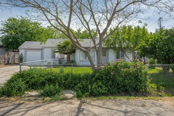 a backyard of a house with lots of green space and fountain