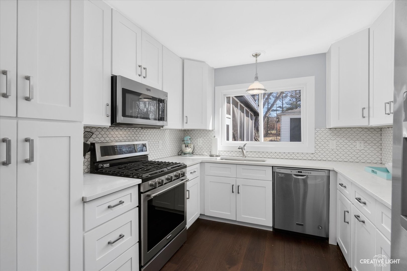 4629 Drendel Road Downers Grove, IL 60515 - Photo 16 of 28 a kitchen with white cabinets and white appliances
