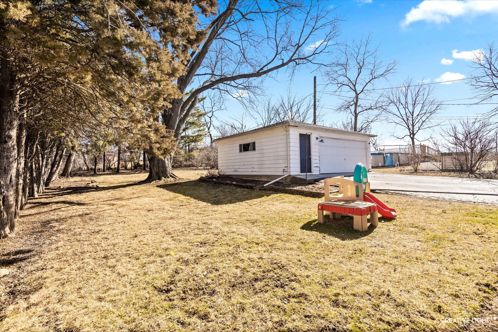 4629 Drendel Road Downers Grove, IL 60515 - Photo 23 of 28 a backyard of a house with fire pit and trees