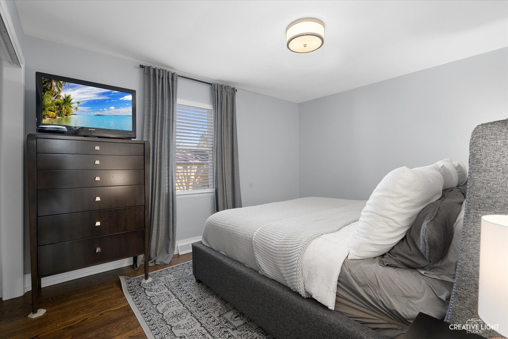 4629 Drendel Road Downers Grove, IL 60515 - Photo 8 of 28 a bedroom with a bed and a flat screen tv