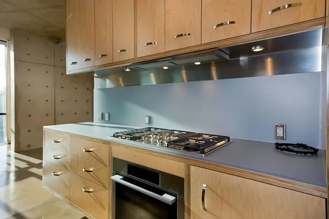 a kitchen with sink and mirror