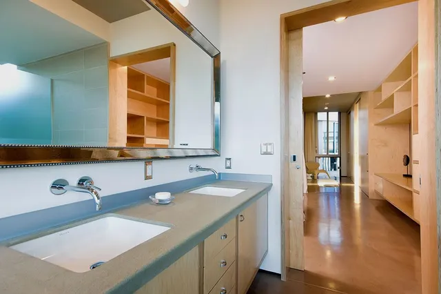 a bathroom with a double vanity sink and a large mirror