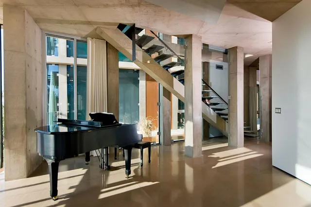 a view of a livingroom with furniture and stairs