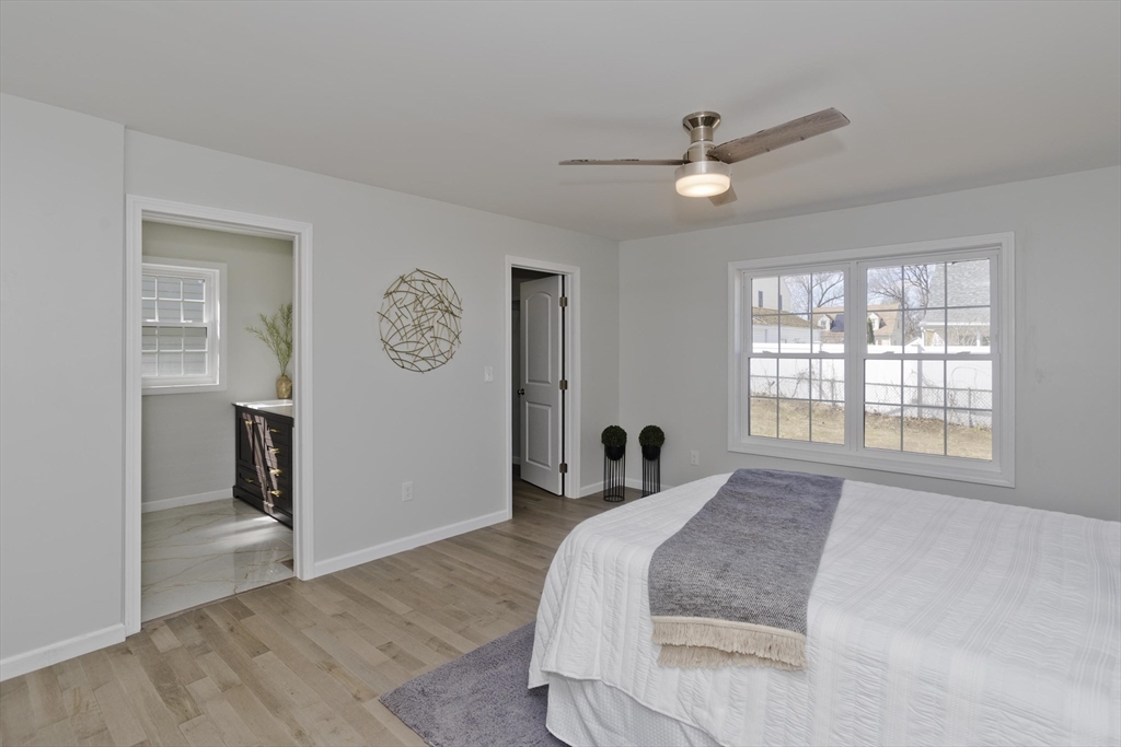 72 Lancaster Street Springfield, MA 01118 - Photo 15 of 35 a spacious bedroom with a bed and a window