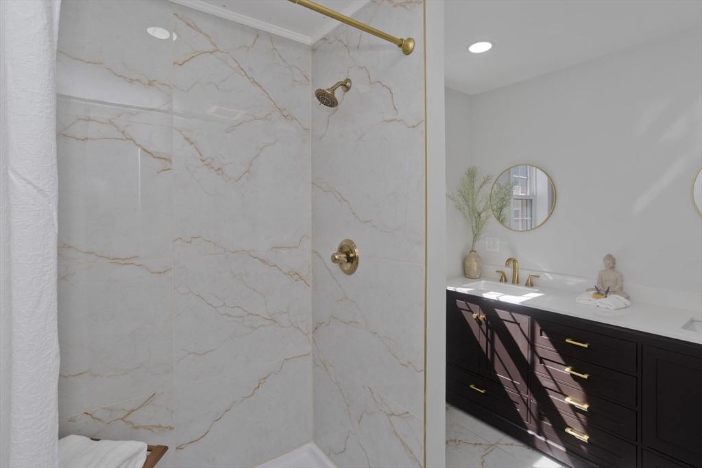 72 Lancaster Street Springfield, MA 01118 - Photo 18 of 35 a bathroom with a sink a light fixture a mirror and a shower