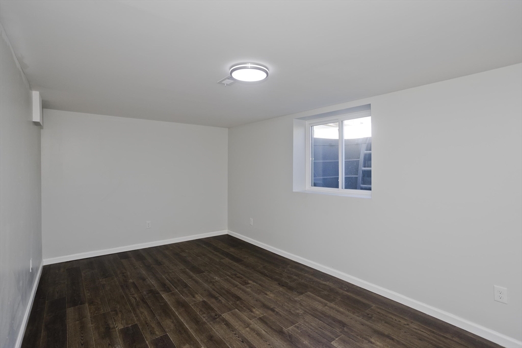 72 Lancaster Street Springfield, MA 01118 - Photo 28 of 35 a view of empty room with wooden floor and fan
