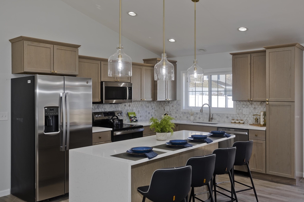 72 Lancaster Street Springfield, MA 01118 - Photo 5 of 35 a kitchen with a sink a counter space stainless steel appliances and cabinets
