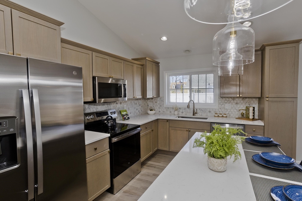 72 Lancaster Street Springfield, MA 01118 - Photo 6 of 35 a kitchen with a sink stainless steel appliances and chandelier