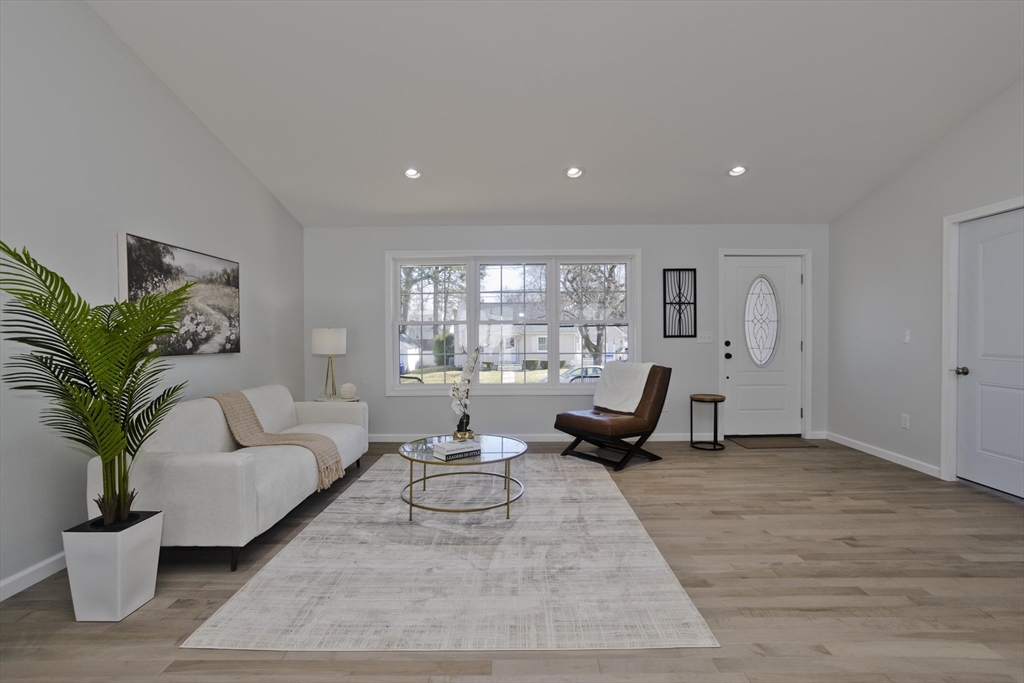 72 Lancaster Street Springfield, MA 01118 - Photo 10 of 35 a living room with furniture floor to ceiling window and potted plant