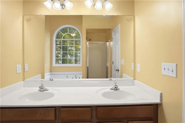 a view of an empty room with closet and a window