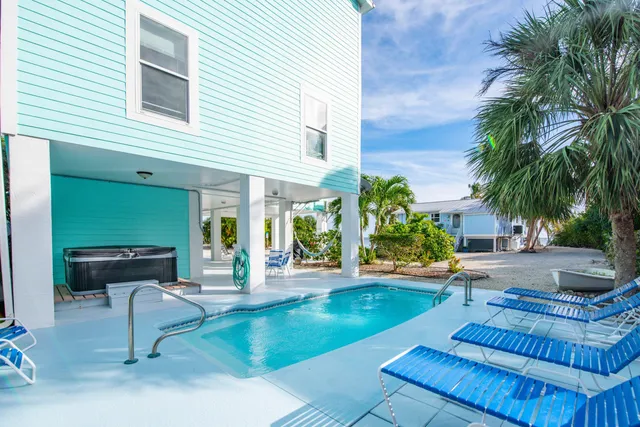 a living room with furniture and large windows
