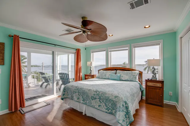 a bedroom with a large bed and a large window