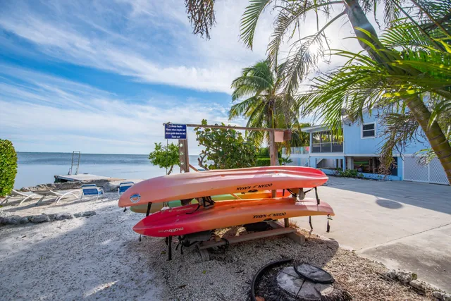 a view of a patio with table and chairs potted plants with wooden floor