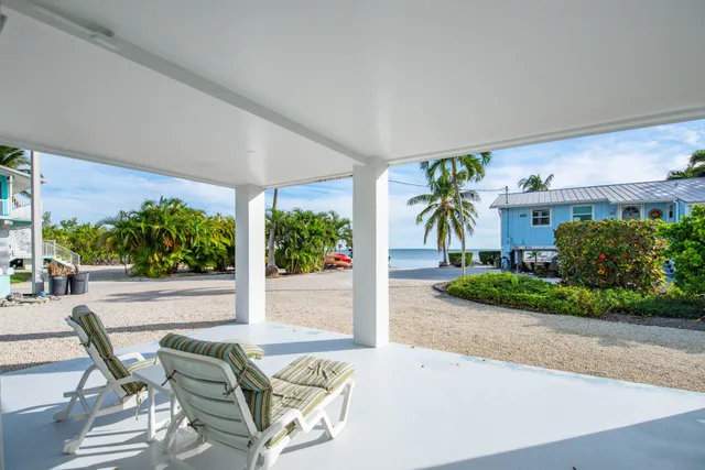 a patio with yard glass top table and chairs