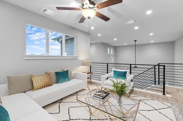 a living room with furniture and a chandelier