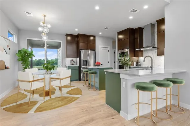 a kitchen with stainless steel appliances kitchen island granite countertop a sink and a granite counter tops
