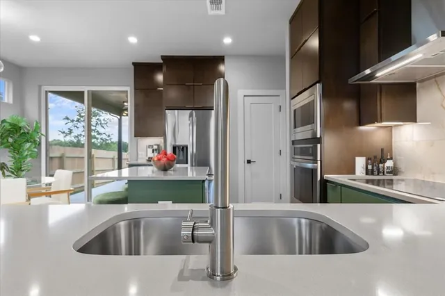 a kitchen with a refrigerator and a sink
