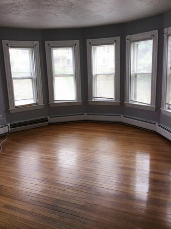 592 Trapelo Road Belmont, MA 02478 - Photo 11 of 23 an empty room with wooden floor and windows