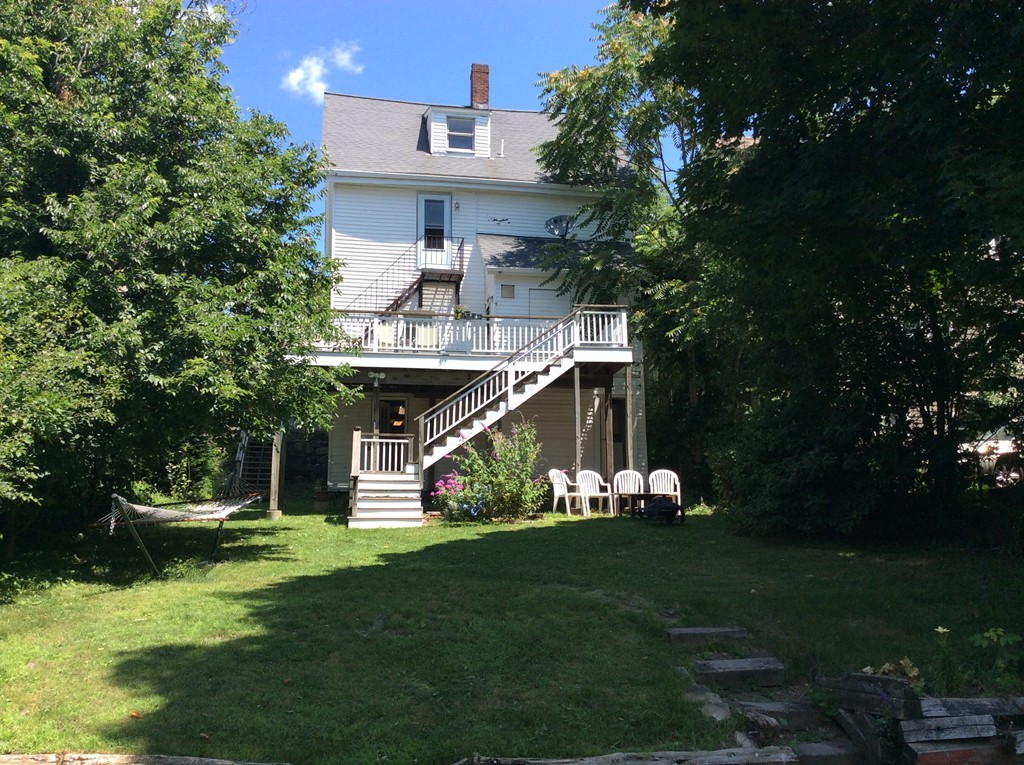 592 Trapelo Road Belmont, MA 02478 - Photo 2 of 23 a front view of a house with a yard table and chairs