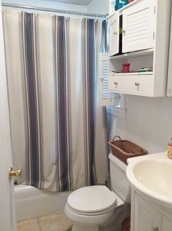 592 Trapelo Road Belmont, MA 02478 - Photo 8 of 23 a white toilet sitting next to a bathroom sink