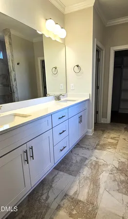 a spacious bathroom with a granite countertop sink and a mirror