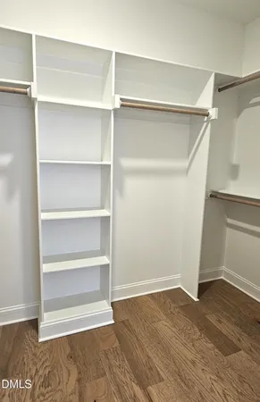 a view of walk in closet with empty racks