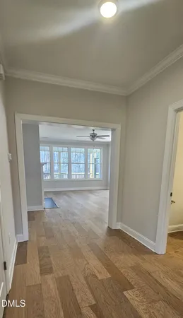 a view of an empty room with window and stairs