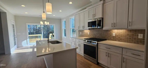 a kitchen with cabinets and steel stainless steel appliances
