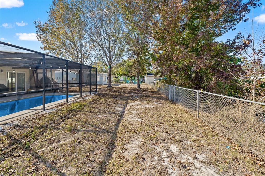 8025 Durham Drive Port Richey, FL 34668 - Photo 15 of 30 a backyard of a house with wooden floor