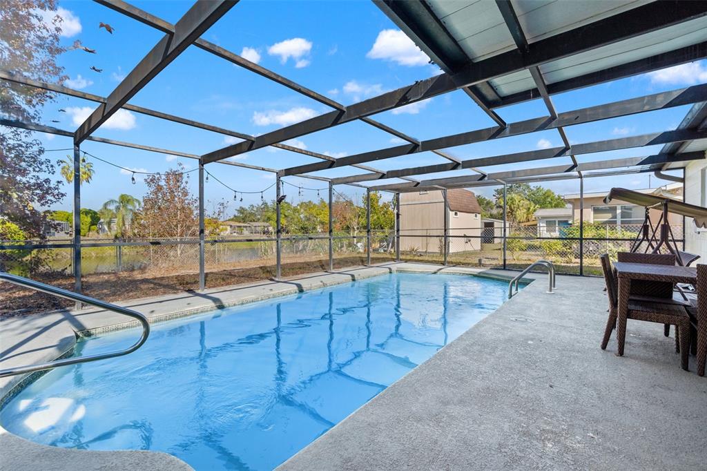 8025 Durham Drive Port Richey, FL 34668 - Photo 3 of 30 a view of a swimming pool with a patio