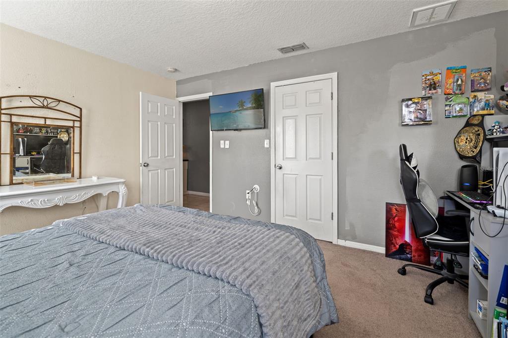 8025 Durham Drive Port Richey, FL 34668 - Photo 7 of 30 a bedroom with a bed and a mirror