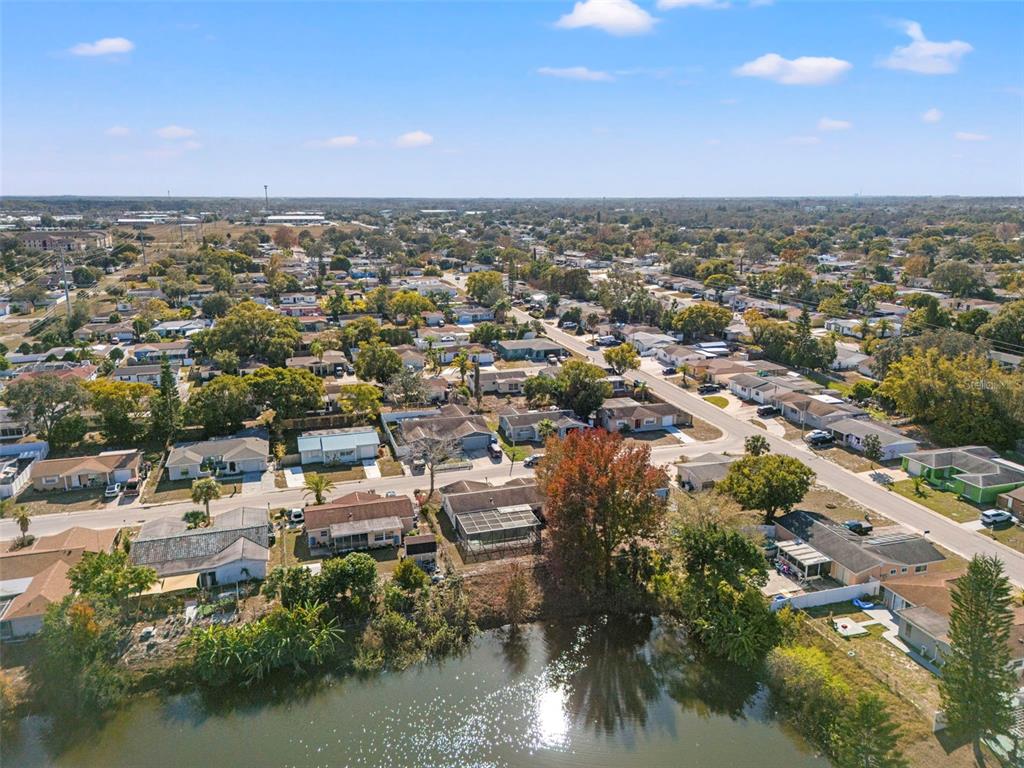 8025 Durham Drive Port Richey, FL 34668 - Photo 8 of 30 an aerial view of a city with lots of residential buildings and ocean view in back