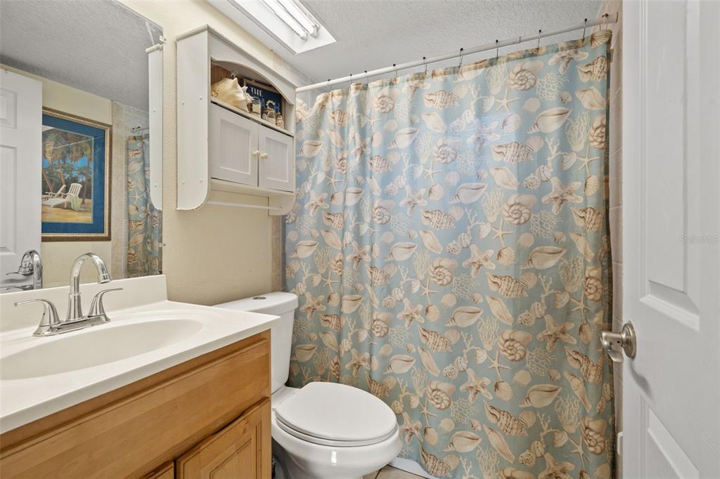 8025 Durham Drive Port Richey, FL 34668 - Photo 10 of 30 a bathroom with a granite countertop sink a mirror and a toilet
