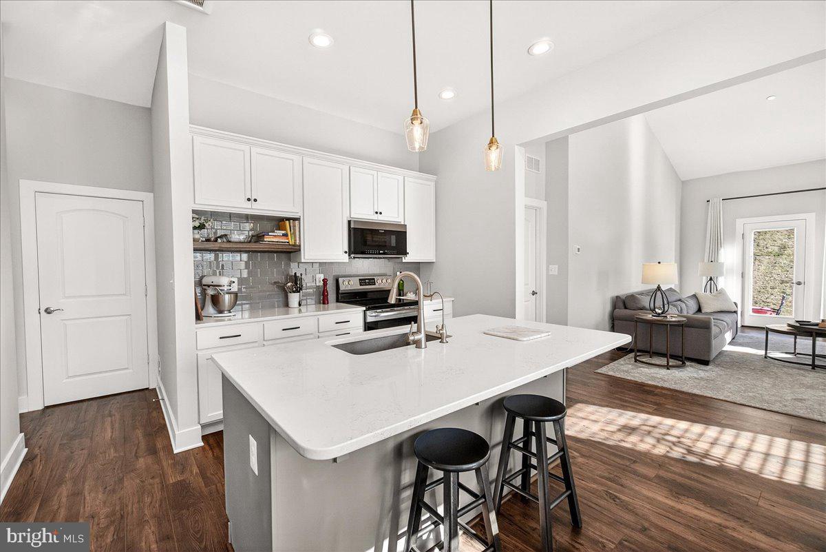2896 Town View Circle New Windsor, MD 21776 - Photo 21 of 45 a kitchen with a table chairs sink and cabinets