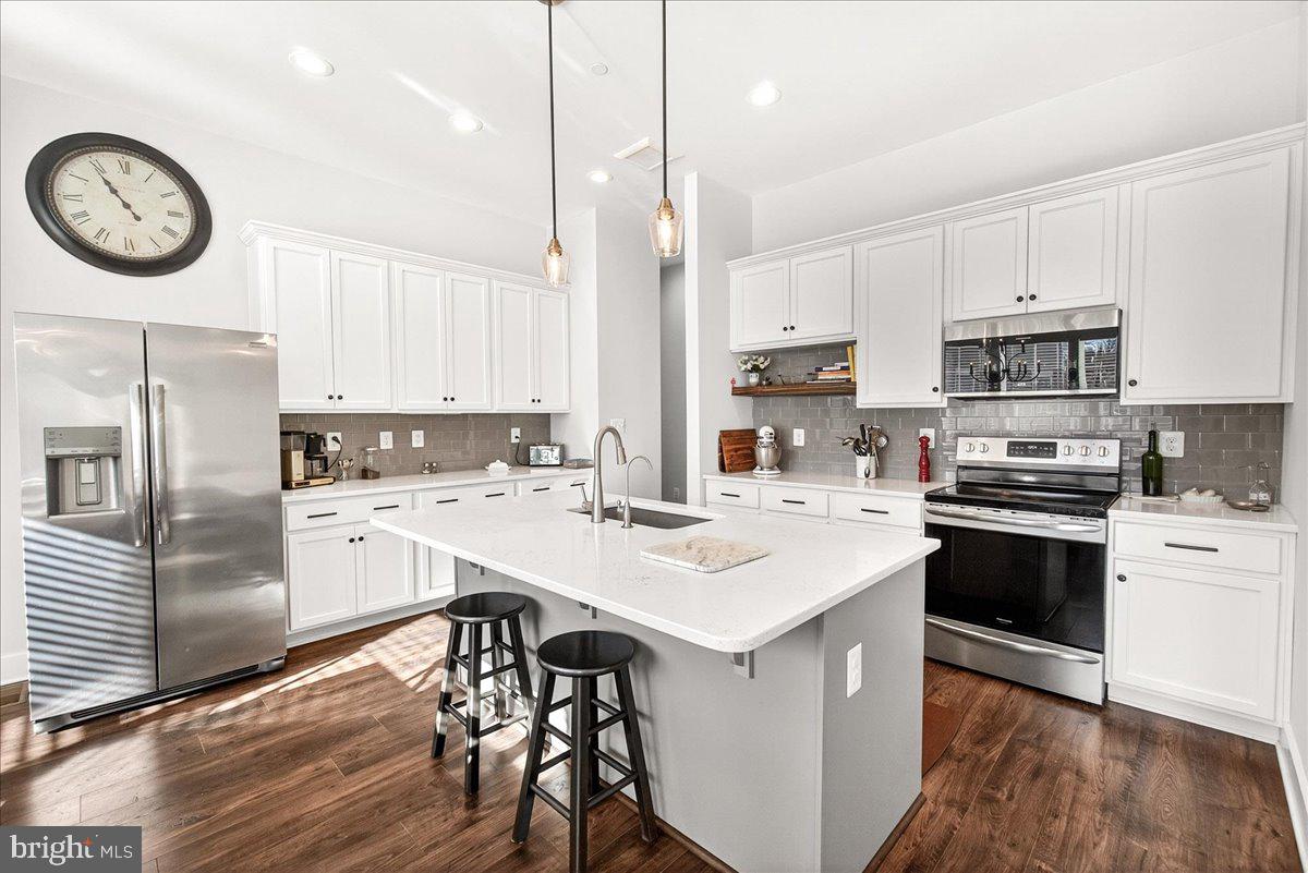 2896 Town View Circle New Windsor, MD 21776 - Photo 22 of 45 a kitchen with a sink a stove a refrigerator and cabinets
