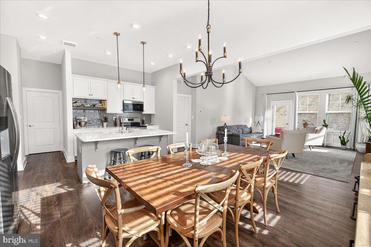 2896 Town View Circle New Windsor, MD 21776 - Photo 25 of 45 a dining room filled chandelier and wooden floor